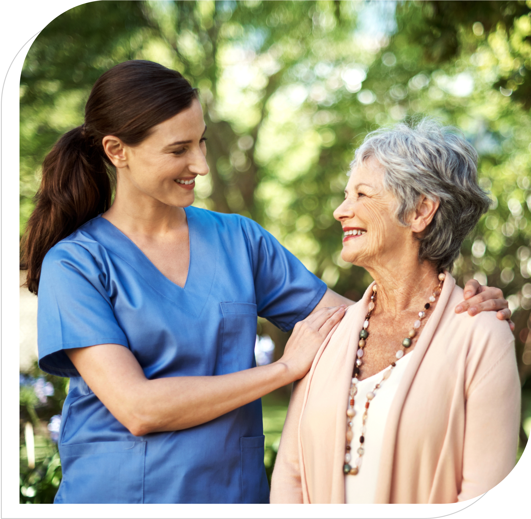 Nurse comforting elderly woman outdoors