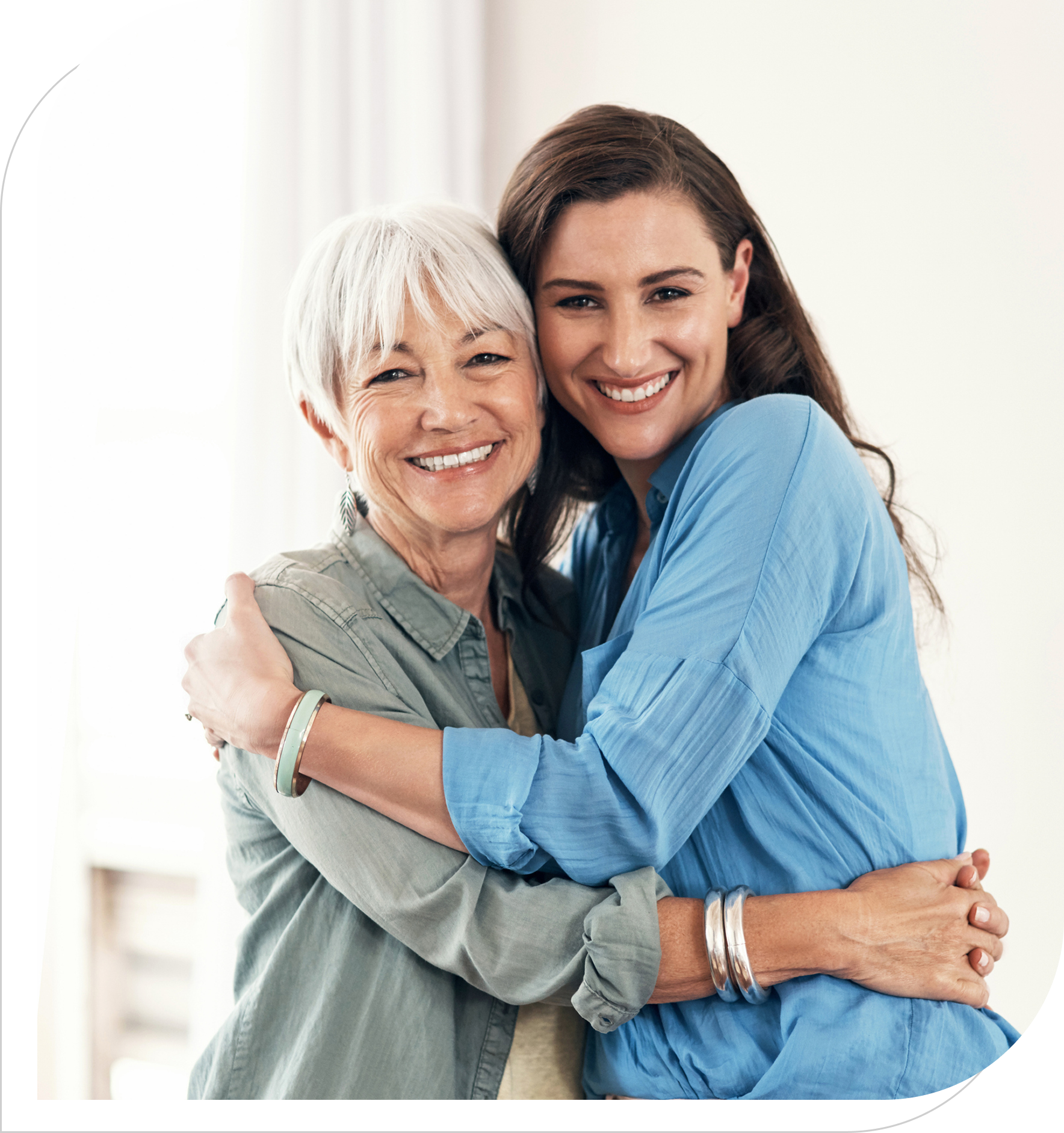 Happy mother and daughter hugging indoors