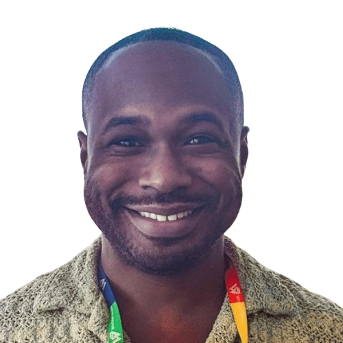 Smiling person wearing patterned shirt and lanyard